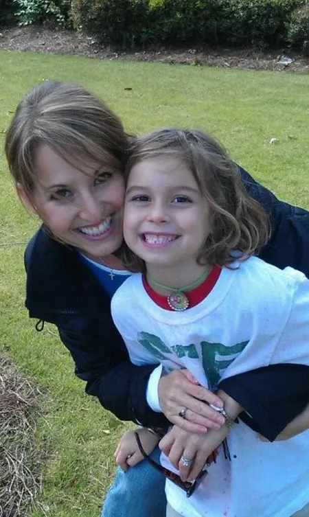 Rhonda hugging a smiling Caroline outdoors on the day of the accident