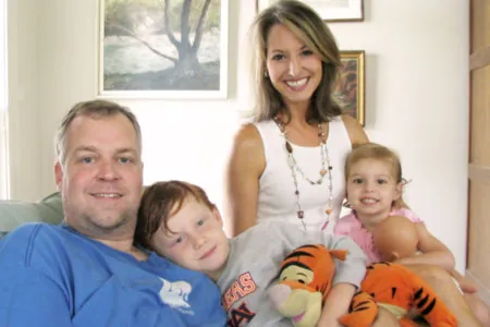 The Wilson family, Philip, Rhonda, Matthew and Caroline, together on the couch at home